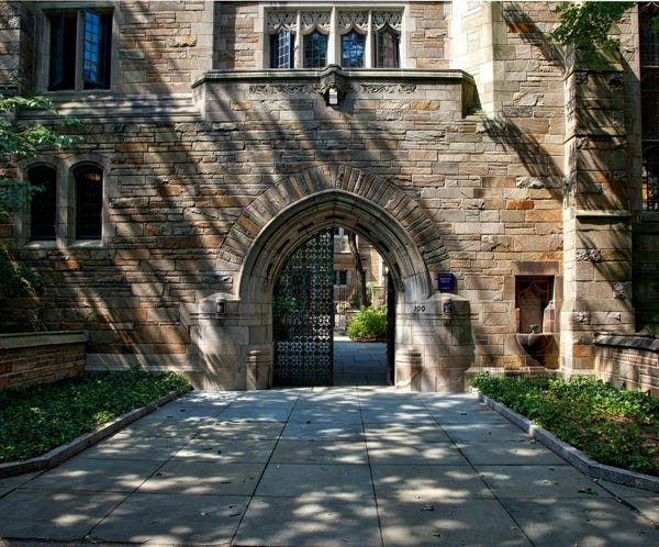 Spacious modern building with courtyard and blue sky, perfect for education themes.